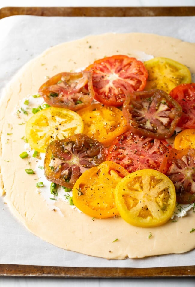 tomato slices on unbaked crostata.
