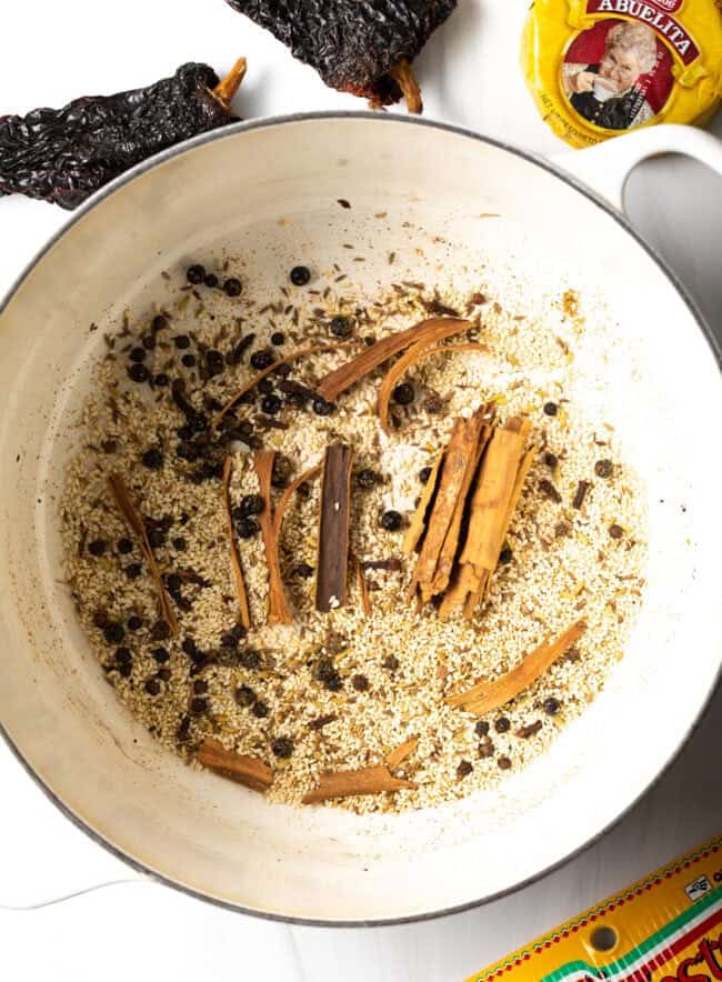 Overhead view of a pot where spices are being toasted. 