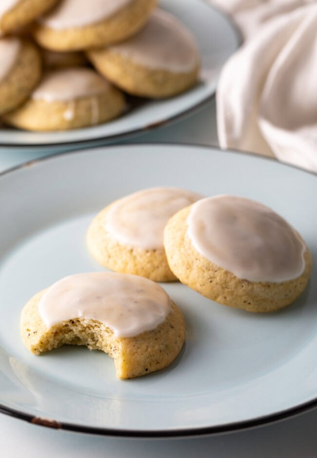 3 Earl grey cookies aka tea cakes on a plate, one with bite taken.