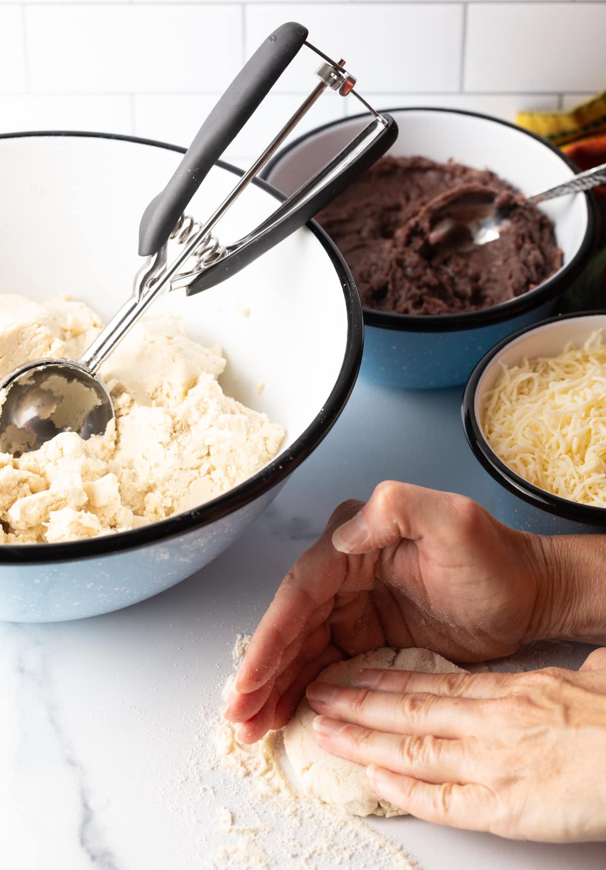Hand flattening dough into thick disc.