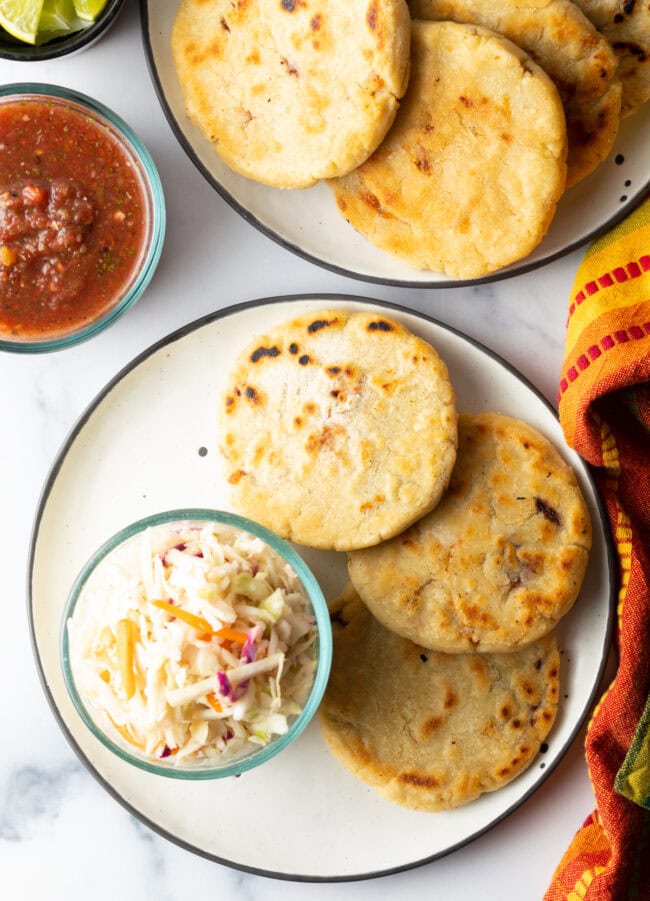 How to Make Pupusas - 
Top down pupusas on a plate with cold slaw.