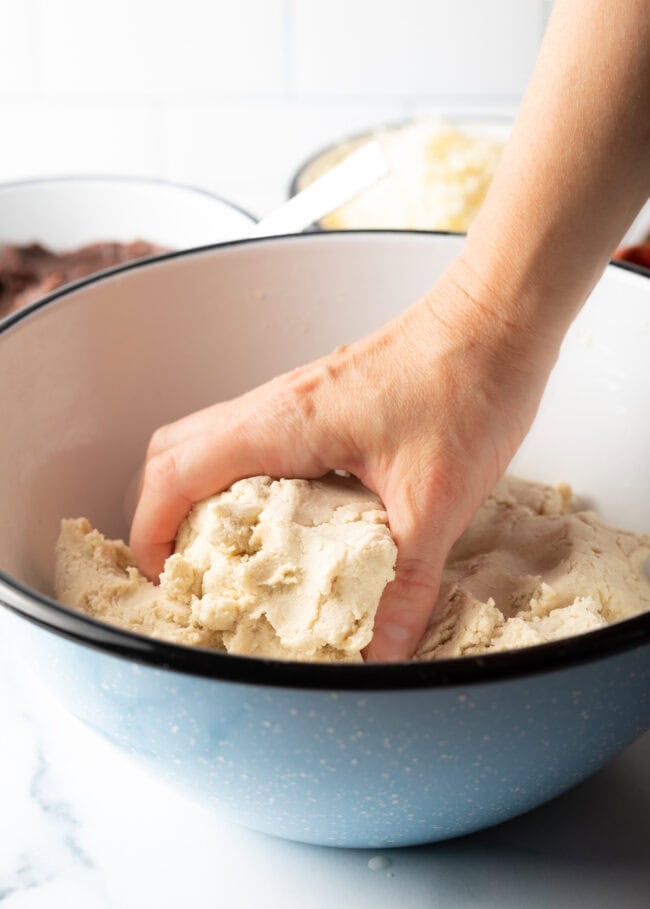 Hand shaping masa harina and water into a soft dough.