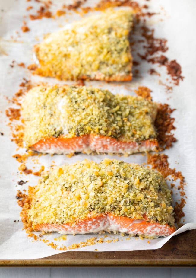 Baked pesto salmon on baking sheet out of the oven.