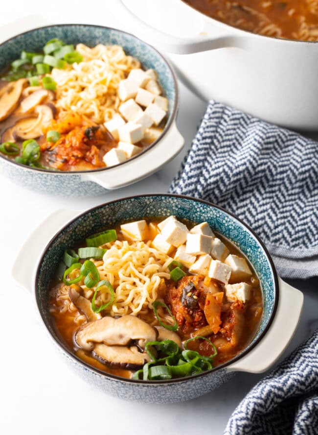 Two bowls of kimchi ramen noodle soup.