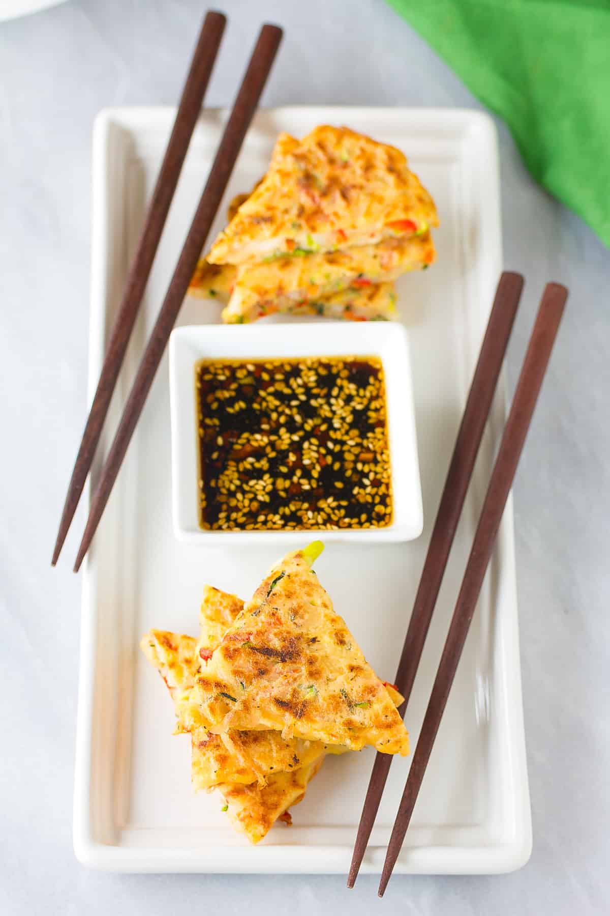 Pajun #ASpicyPerspective #KoreanPancakes #KoreanPancakeRecipe #Pajun #Pajeon #Korean #Vegetarian pajeon pancakes cut on serving tray