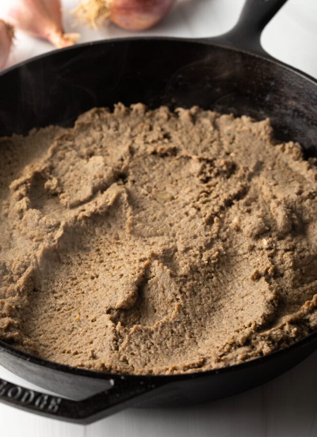 Closeup of mushroom mixture being sauteed in pan.