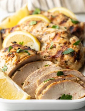 Close view pieces of marinated grilled chicken with lemon.