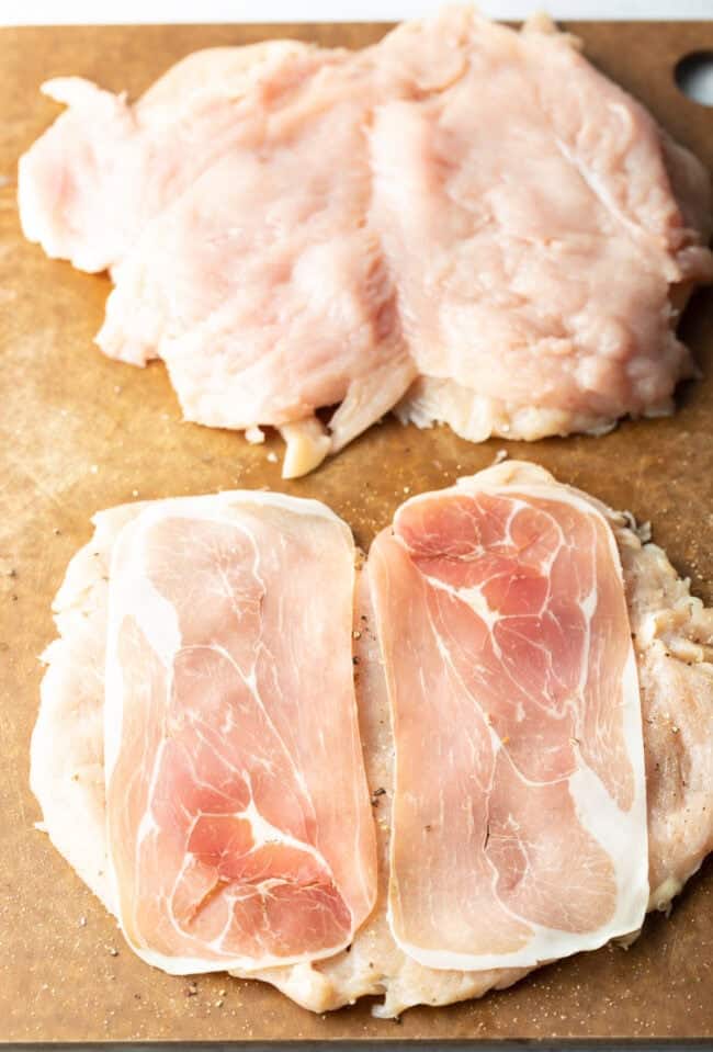 Butterflied chicken with slices of prosciutto on each half.