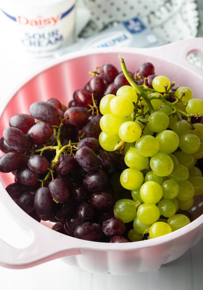 Green bunch and red bunch in a large white bowl.