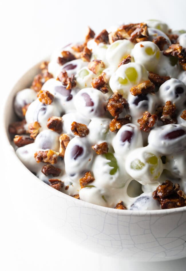 Close top down view salad made with green and red grapes, cream cheese, and pecans.