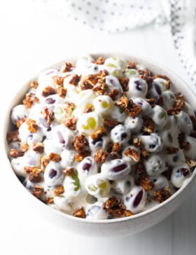 Grape salad in a white bowl.