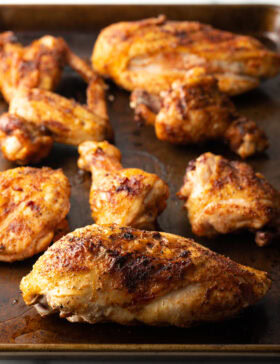 Smoked poultry pieces on a cutting board.