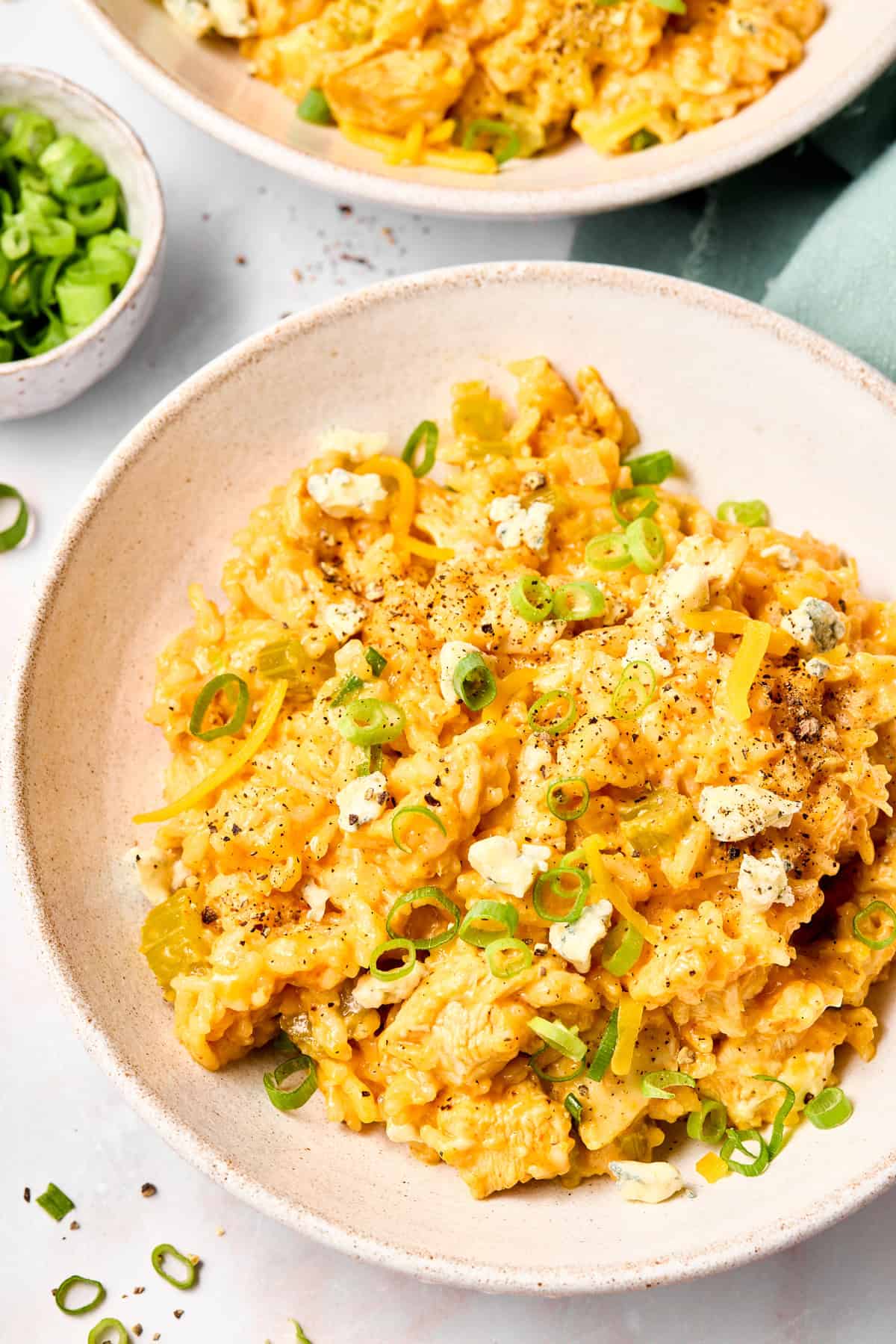 Buffalo Chicken Rice Recipe in ceramic dishes with garnishes