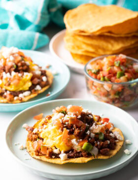 Loaded breakfast tostada on a plate.