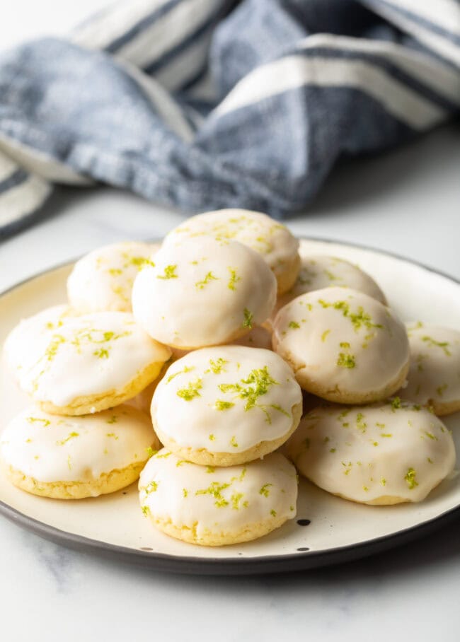 White plate piled with glazed key lime cookies.