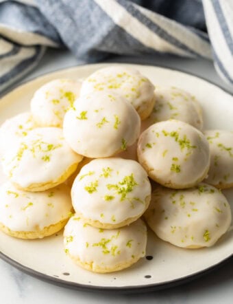 White plate piled with glazed key lime cookies.