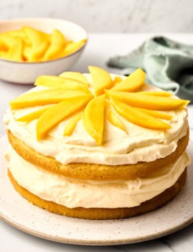 Tres Leches Cake Recipe with Mango Cream - whole cake on plate side angle