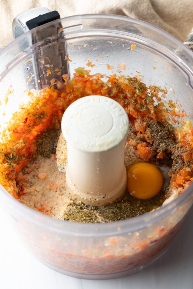 Minced veggies and spices in a food processor.