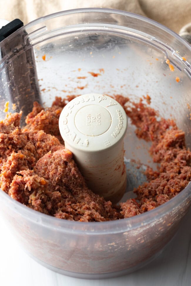 Food processor with meat and spices.