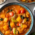 Close view of Thai pumpkin curry in speckled blue bowl.