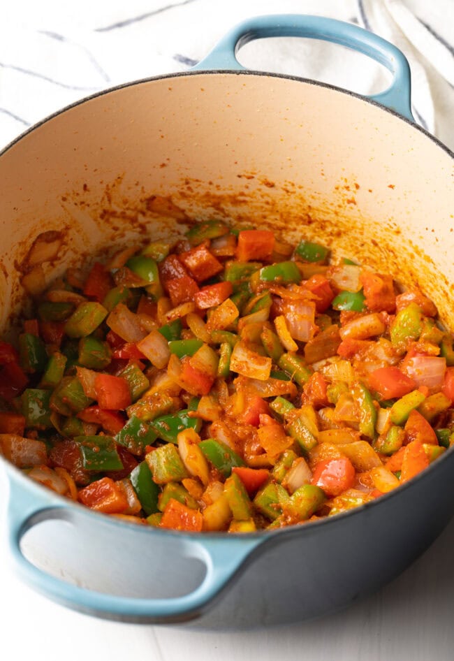 Mixed veggies sauteing in a cooking pot.