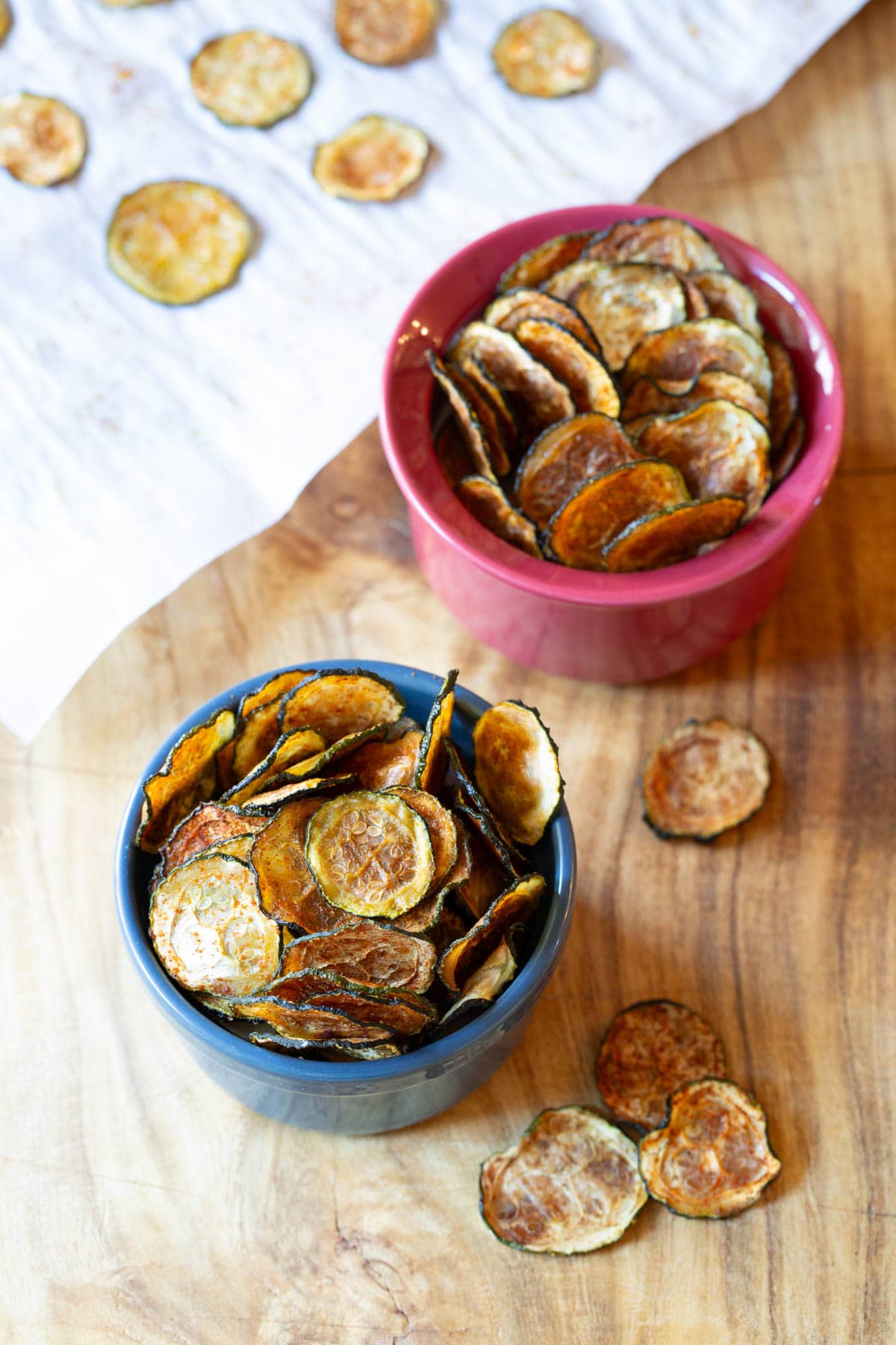 Baked Zucchini Chips #ASpicyPerspective #Healthy #Paleo #Vegan #GlutenFree #Vegetarian #ZucchiniChips #OvenRoasted Baked Zucchini Chips - overhead shot of chips in two bowls