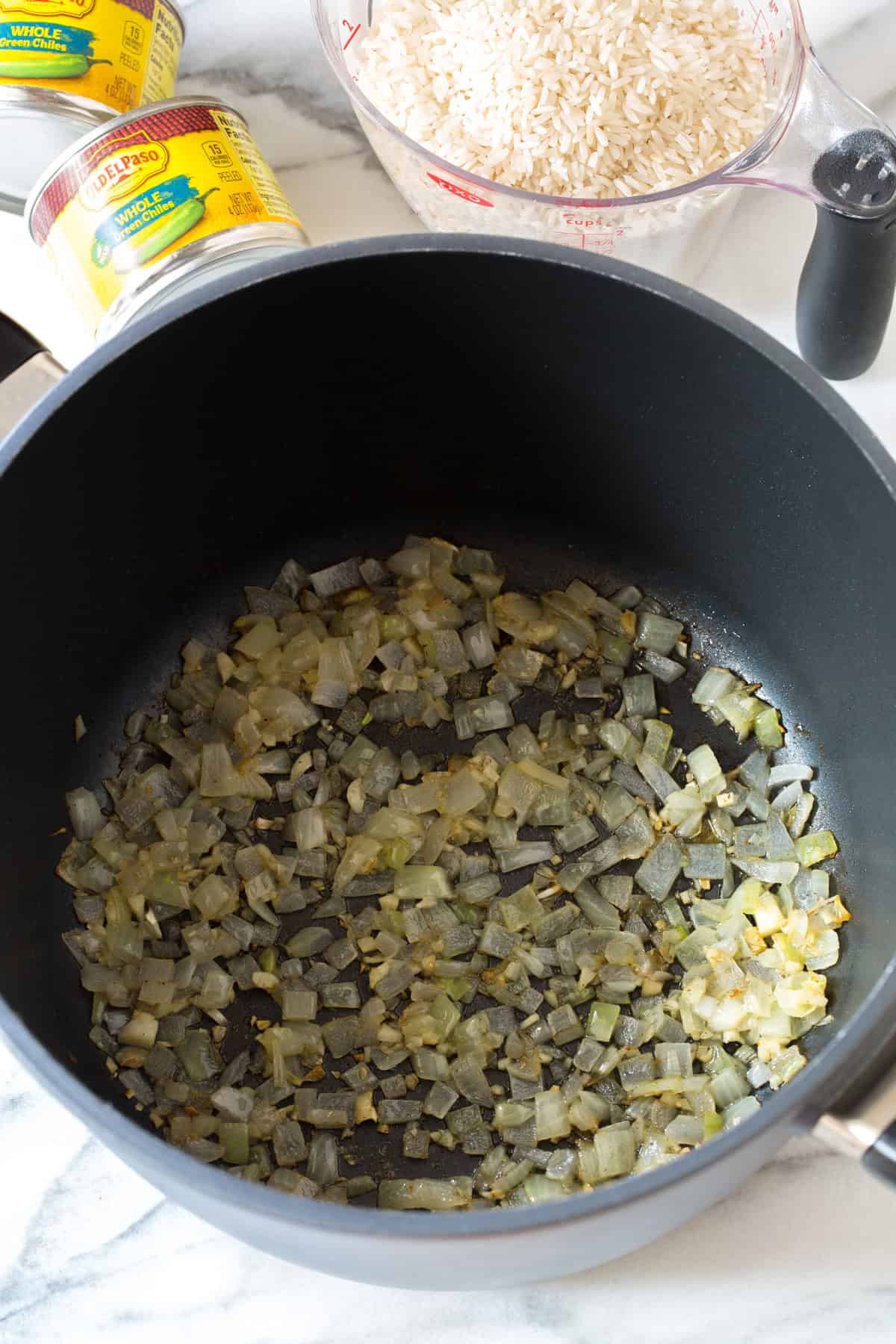sauteed onions in pot with green chiles