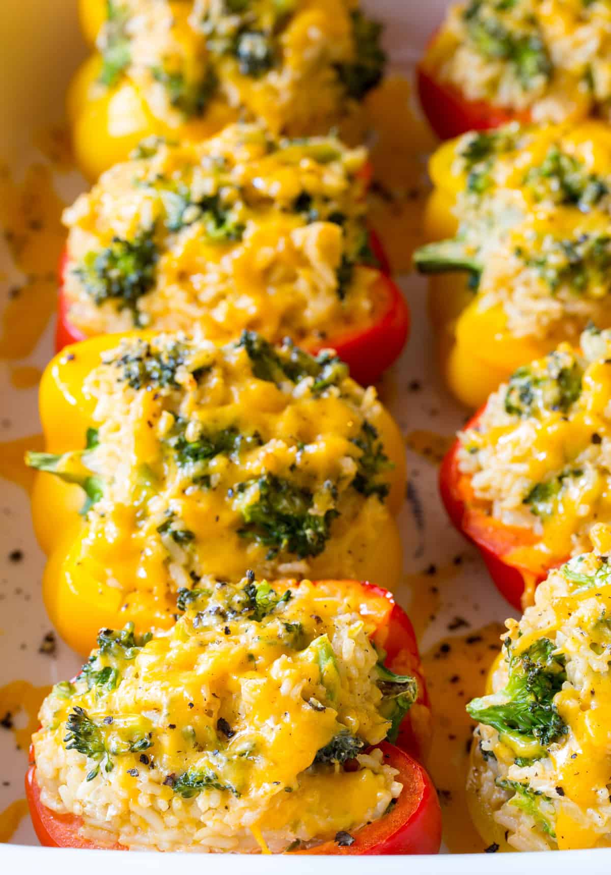 close up of baked rice stuffed peppers with cheese