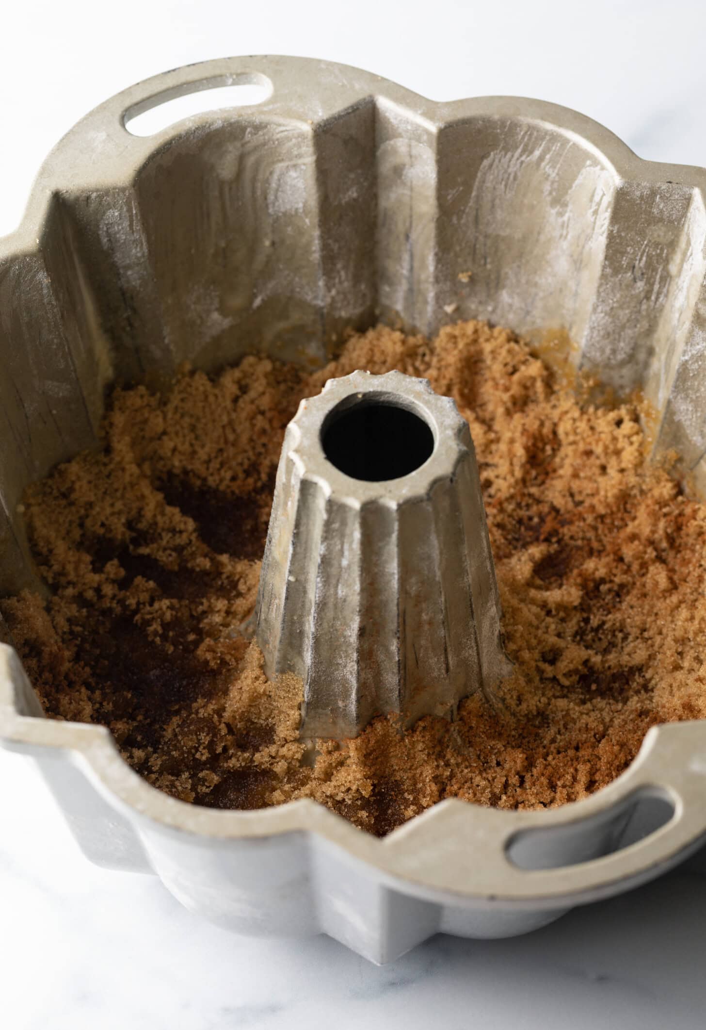 Brown sugar lining the bottom of a bundt pan.