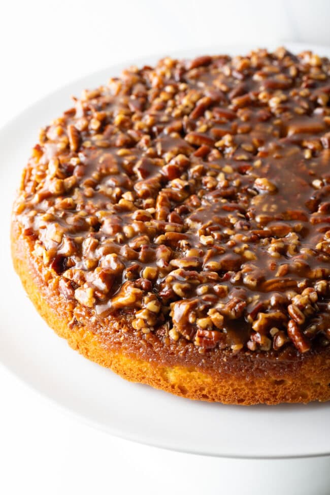 Side view of a whole upside down pecan pie cake.
