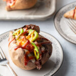 Single stuffed Hawaiian style sweet potato on a white plate.