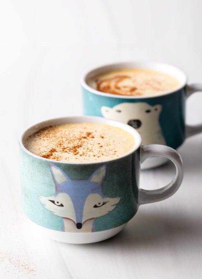 Two mugs of Vietnamese egg coffee. with frothy tops