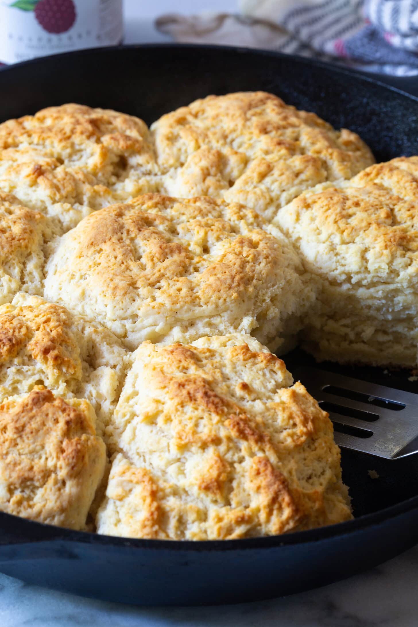 Fluffy Cat Head Biscuit lifted out of skillet.