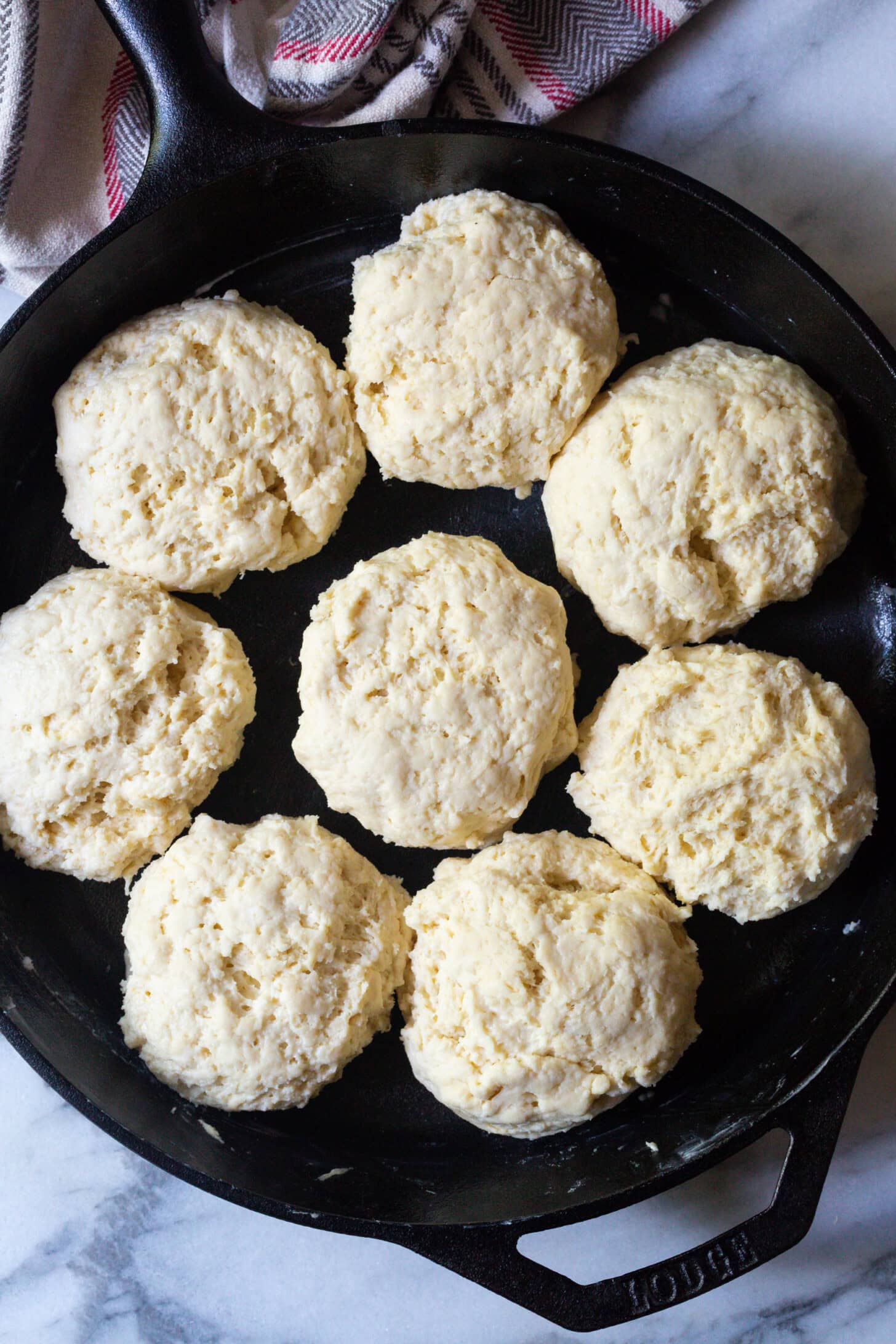 Uncooked biscuits placed into skillet. 