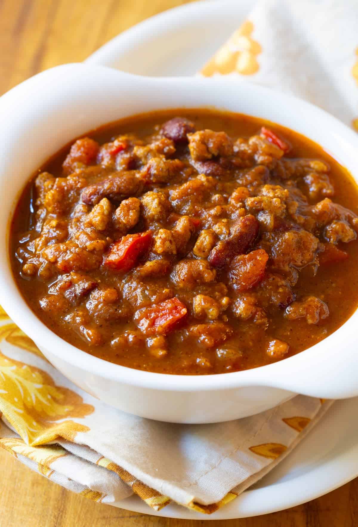 pork pumpkin chili in bowl with tomatoes and spices