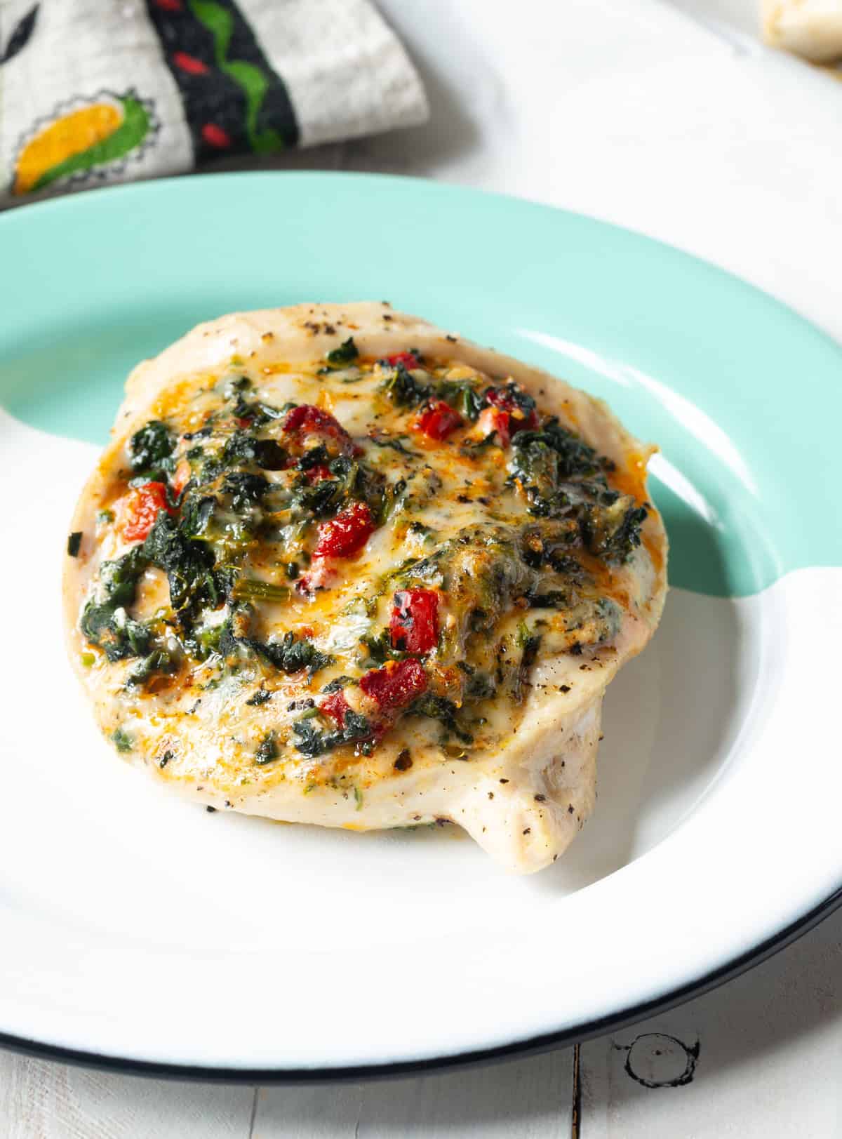 Cheesy Spinach Stuffed Chicken Breasts Recipe on green and white plate