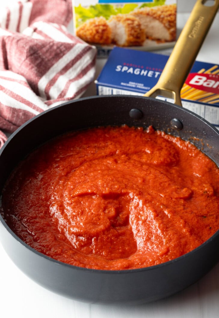 Marinara sauce in a deep black skillet.