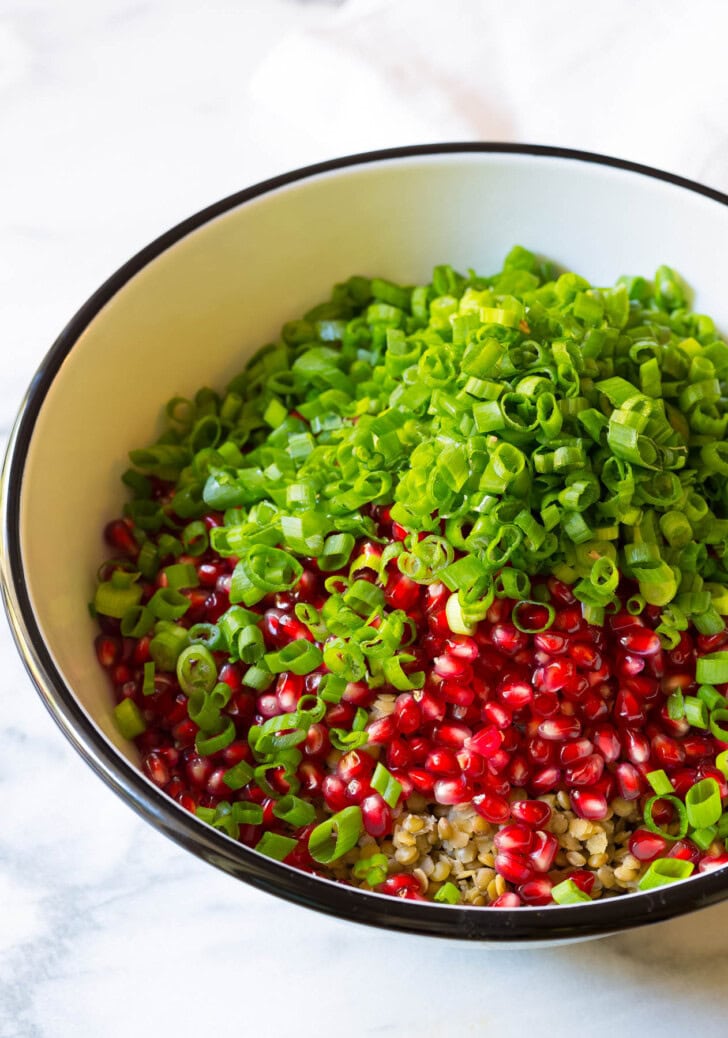 Ingredients for lentil salad in a bowl before being mixed. 