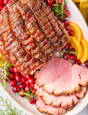 Brown Sugar Ham (Baked Ham Glaze Recipe) sliced ham on platter with garnishes