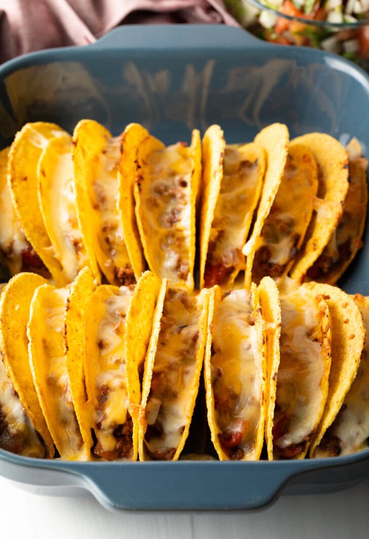 Cheese melted in the rows of tacos.