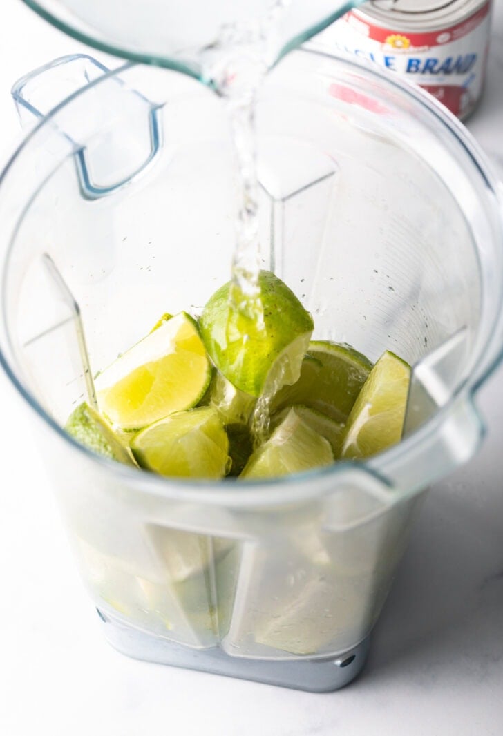 Blender with limes and water.