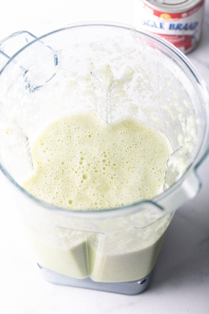 Frothy limeade base in a blender jar.