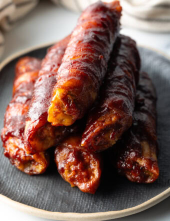Pyramid tower of smoked shotgun shells on a gray plate.