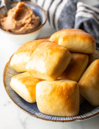 Stack of rectangle Texas Roadhouse rolls.