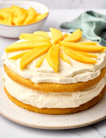 Tres Leches Cake Recipe with Mango Cream - whole cake on plate side angle