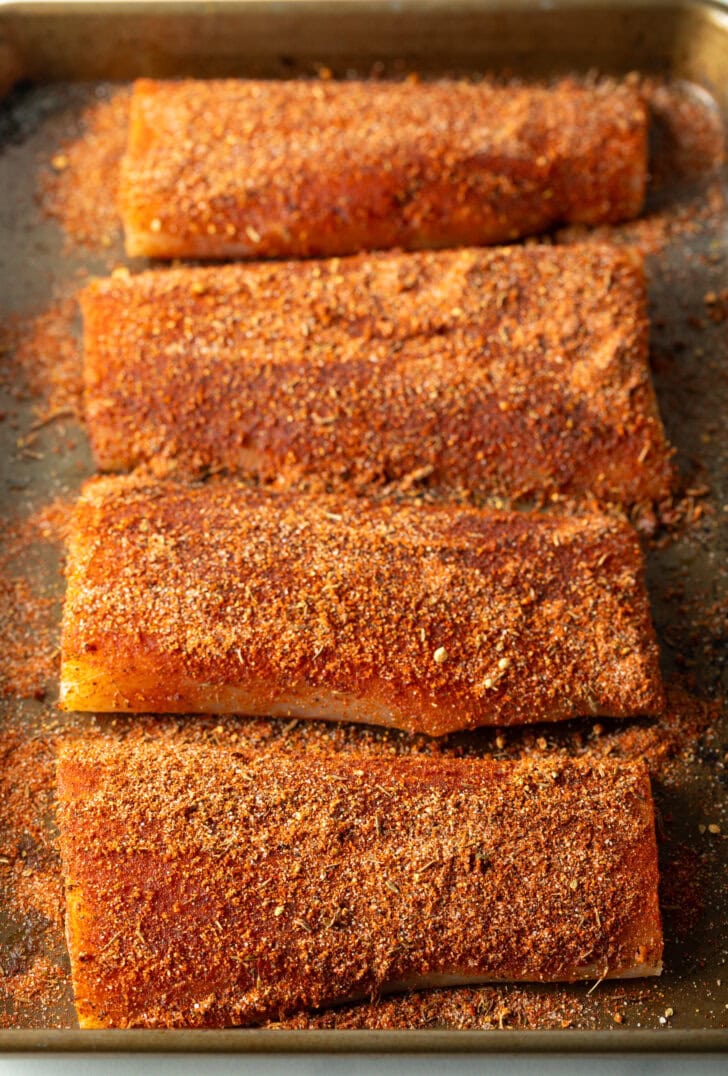 4 pieces of raw fish fillets coated with homemade blackening seasoning.