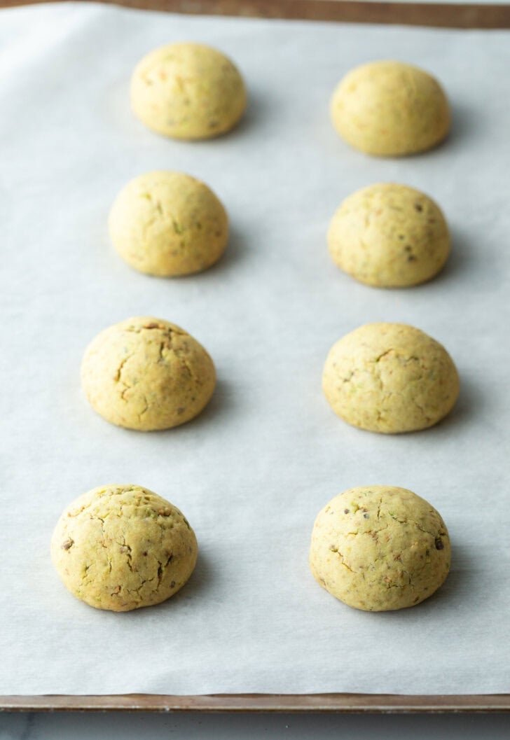 8 balls of cookie dough on a baking sheet.