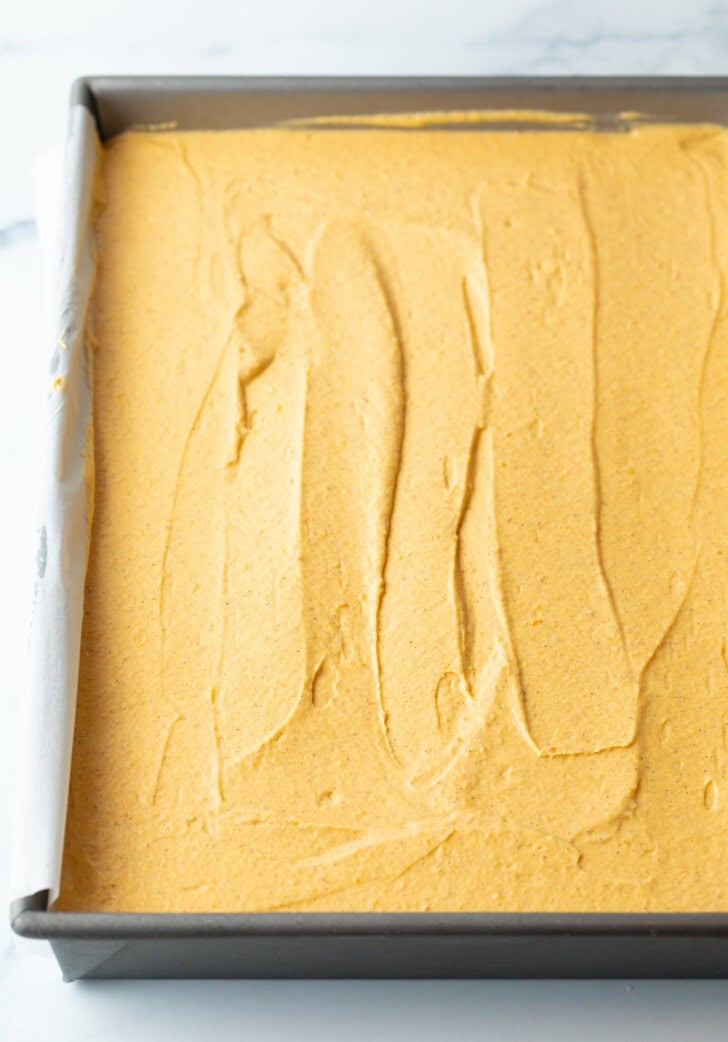 Smooth pumpkin cheesecake in a rectangle baking dish.