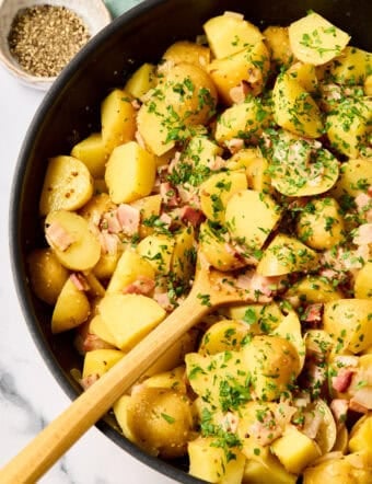 Hot German Potato Salad Recipe in pan with wooden spoon