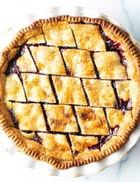 Top down view finished baked pie with diamond pattern crust.